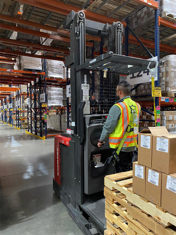 Person in warehouse driving a forklift